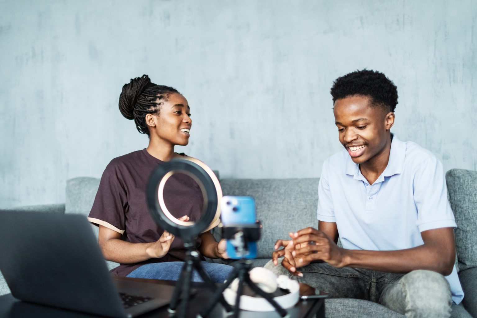 Two podcast hosts recording a show together