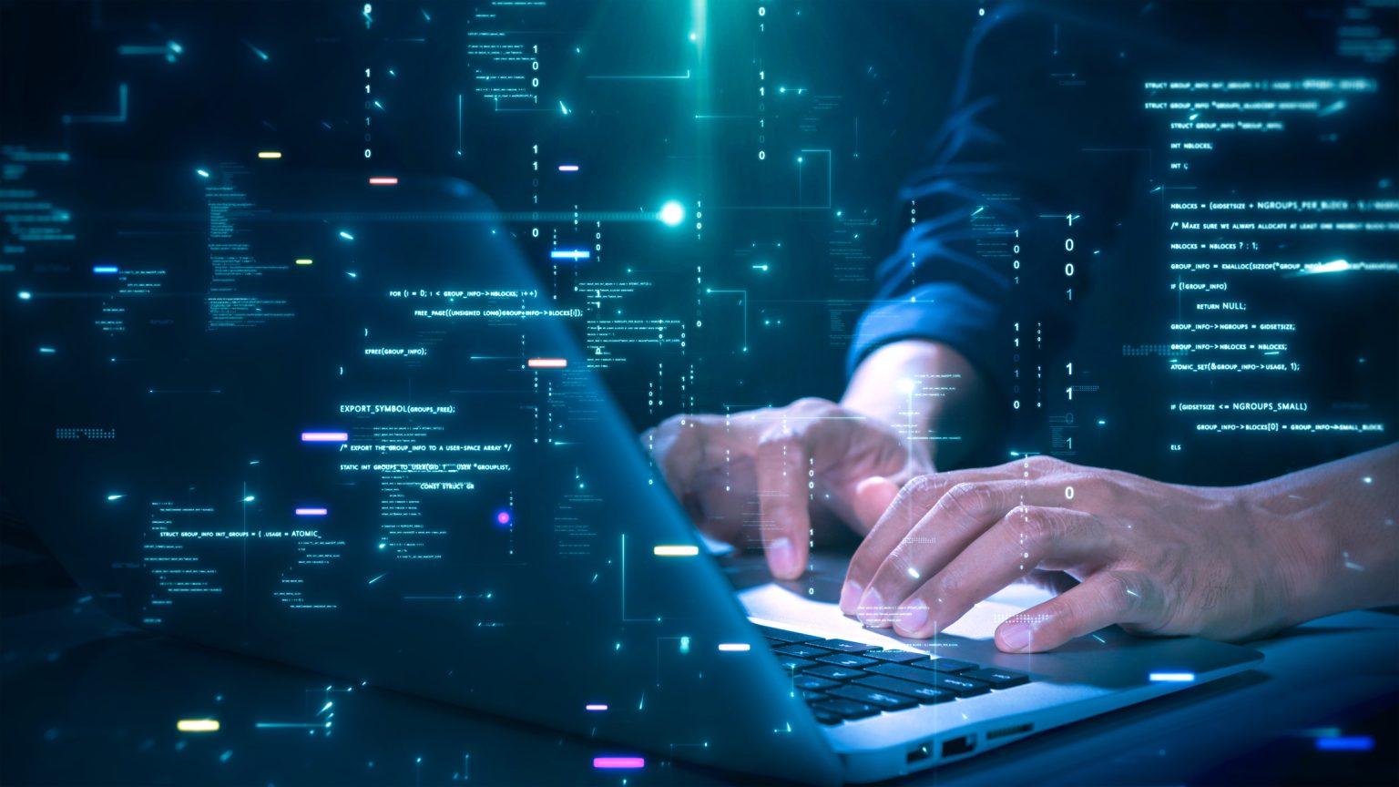 Hands typing code on a laptop