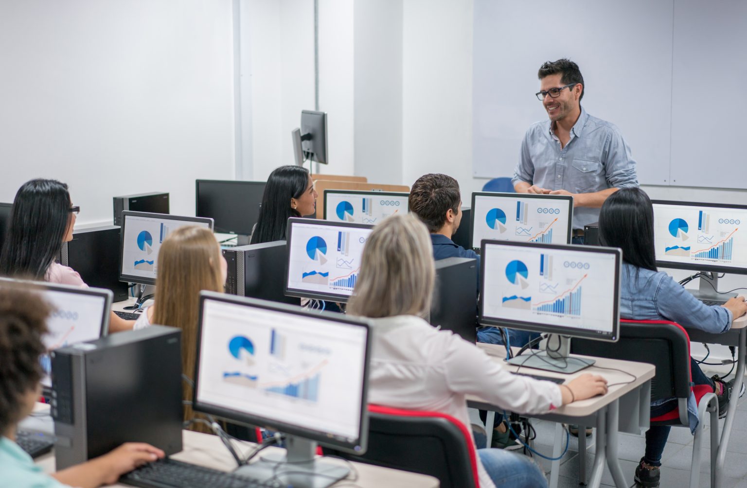 An instructor leading a computer-lab training session