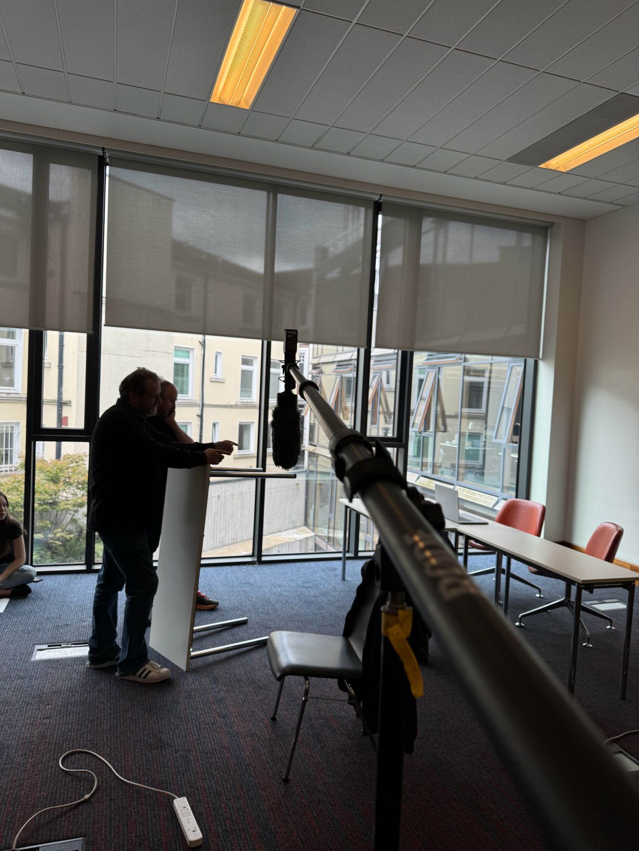 Boom microphone in position as the crew sets up a Be the Boss scene