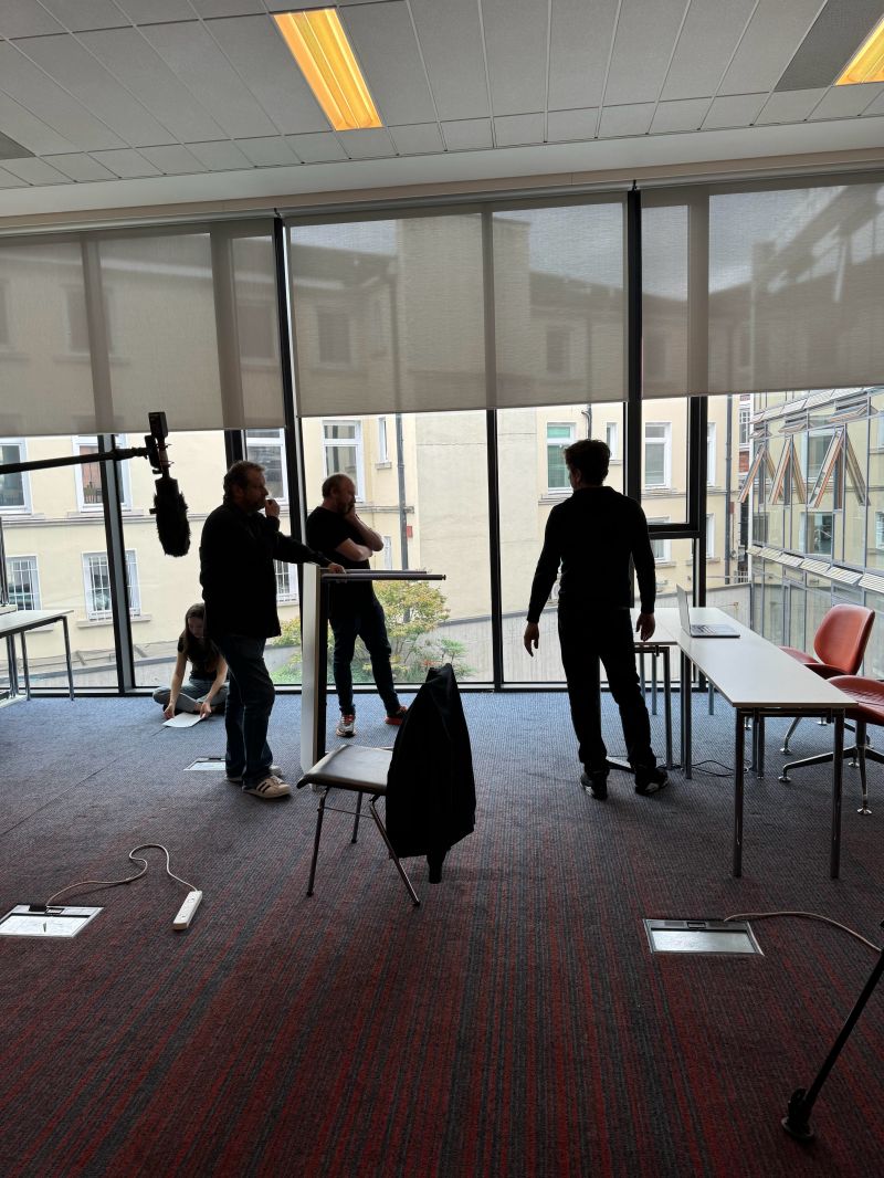 Crew rehearsing a scene with a boom microphone on the Be the Boss set