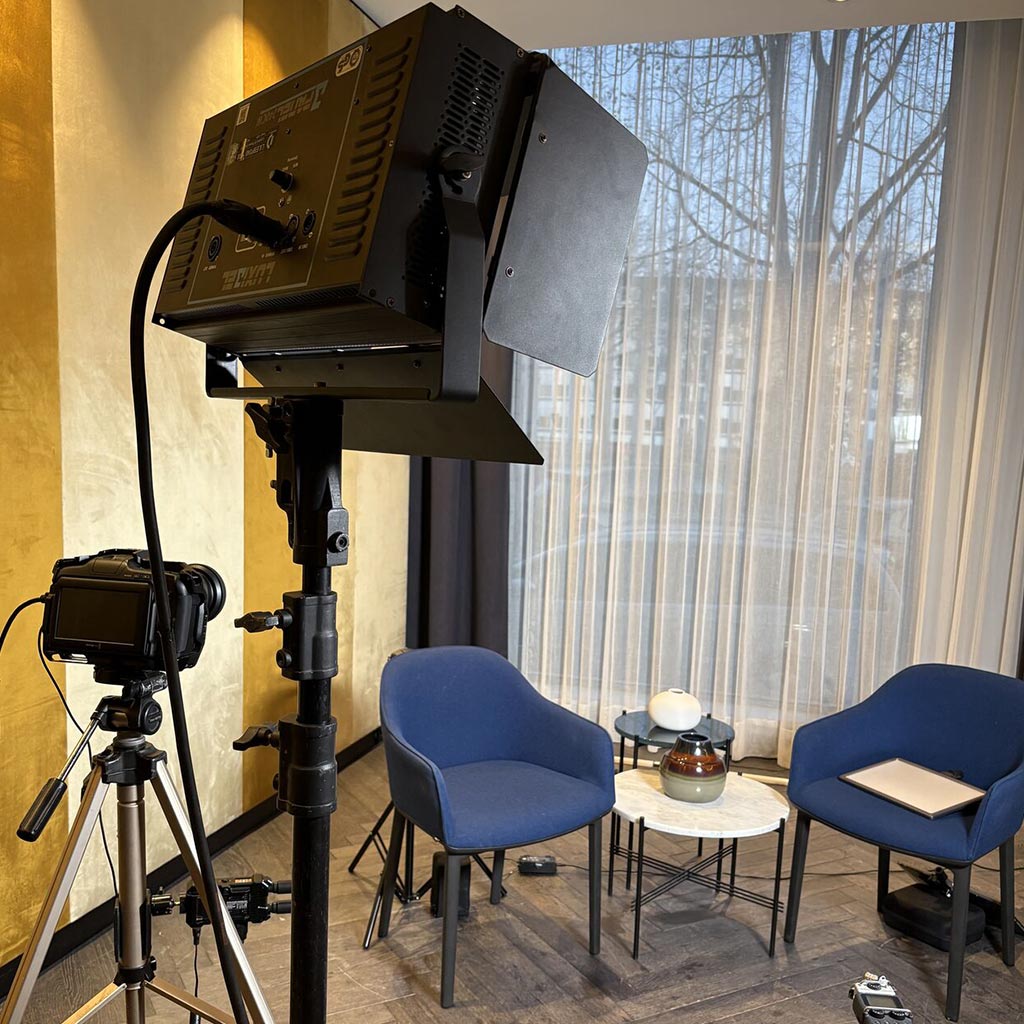 Interview set with two chairs and a side table, lit for filming in Amsterdam