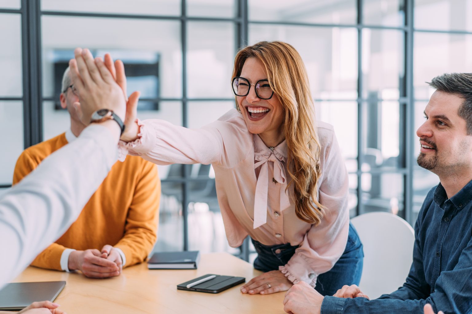 Colleagues celebrating a project with a high five